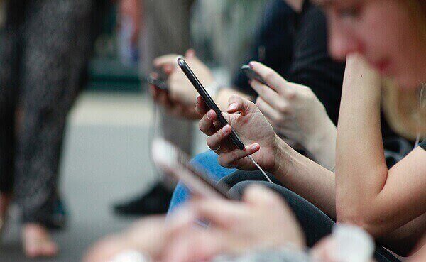 people-engaged-phone-outdoor