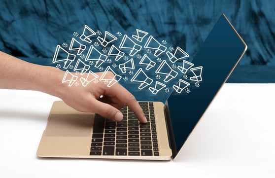 Laptop with flying email icons flying out.
