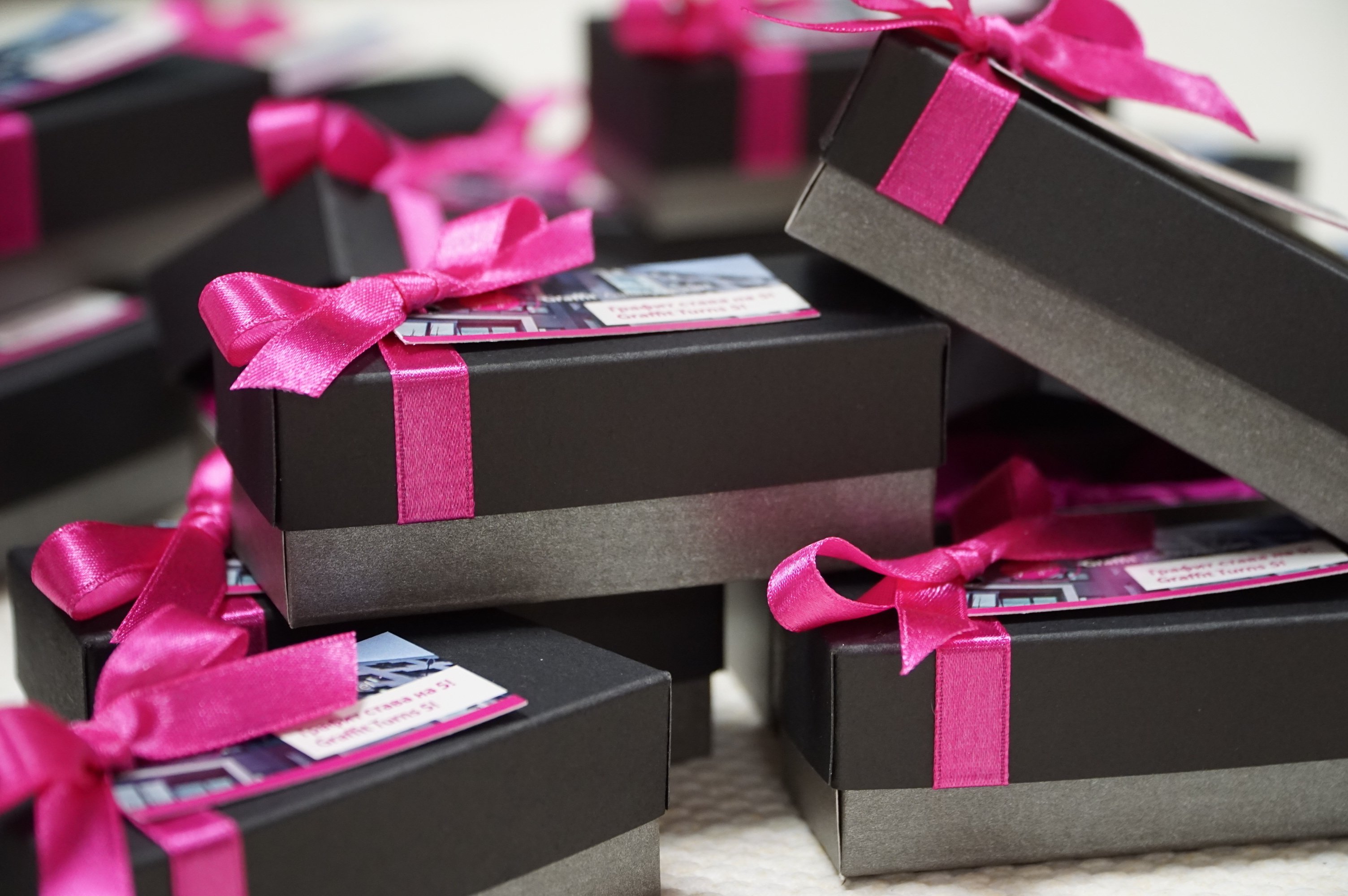Social media content ideas featuring neatly packaged gift boxes with pink ribbons, perfect for giveaways or contests.