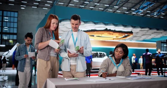 A group of marketing team members at a trade show for brand awareness
