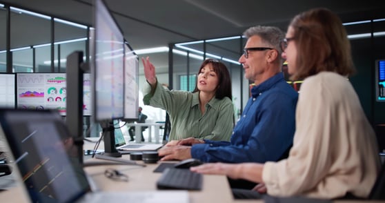 A Consultant Working with Business Owner Clients showing them reports for SEO and AI Search