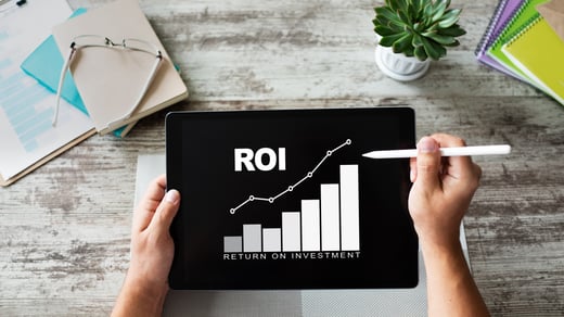 ROI chart on tablet screen used to track paid search tactics performance and improve return on investment.