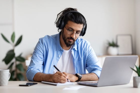 Young Guy In Headphones Studying With Laptop
