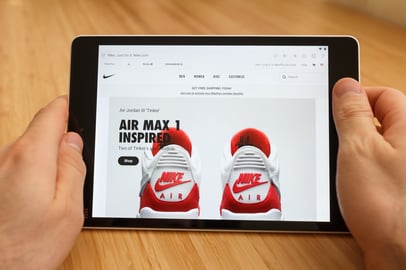 Omnichannel marketing showing customer shopping on Nike’s eCommerce site via tablet.