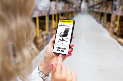 Omnichannel marketing for a furniture brand with mobile shopping in a warehouse setting.