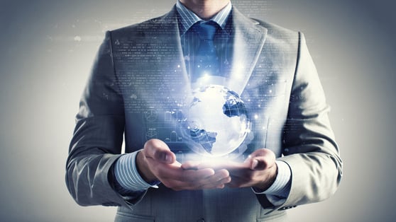 Man in suit holding a digital world in his hands.