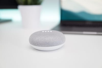 Google mini on a white table.