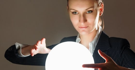 Woman in front of a glowing crystal orb.
