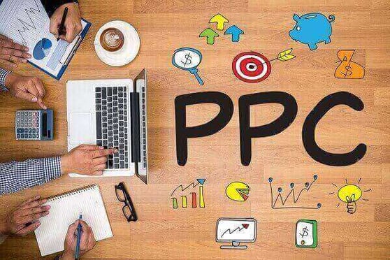 Graphic of PPC written on a desk, with a various people working around a laptop.