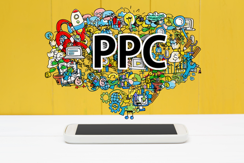 Graphic of a tablet on a table with a PPC word cloud floating above it.