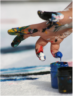 Photo of child's hand with different paint colours.