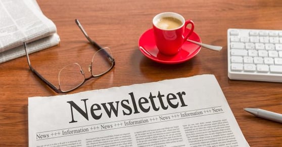 Photo of a newletter sitting on a wooden table.