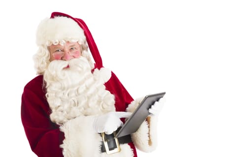 Image of Santa Claus reviewing a list.