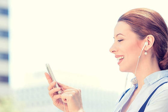 Lady holding a phone and smiling