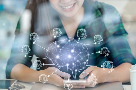 Smiling woman holding cellphone with polygonal brain shape of an artificial intelligence with various icons floating.